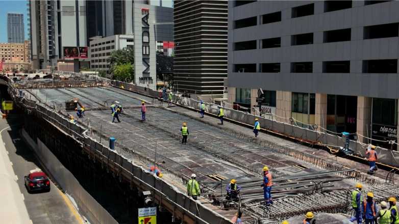 Close up of bridge construction with workers and steel structure